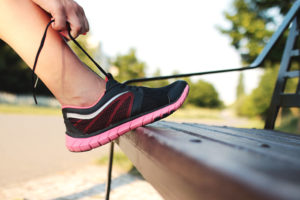 A person tying their trainers