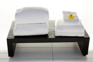 White towels on a bench, towels make great vegan travel supplies