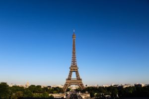 The Eiffel Tower in Paris shot form a distance against a bright blue sky